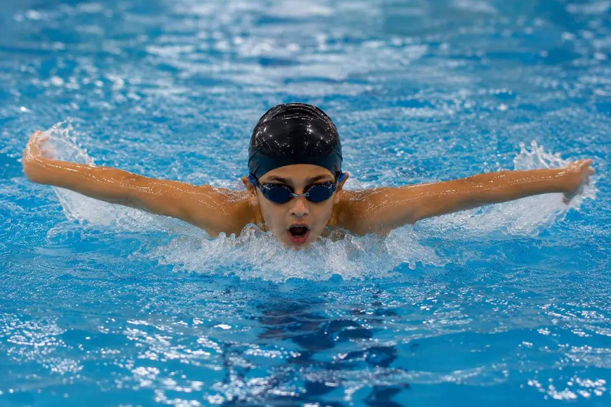 A boy swimming butterfly at Ashbal